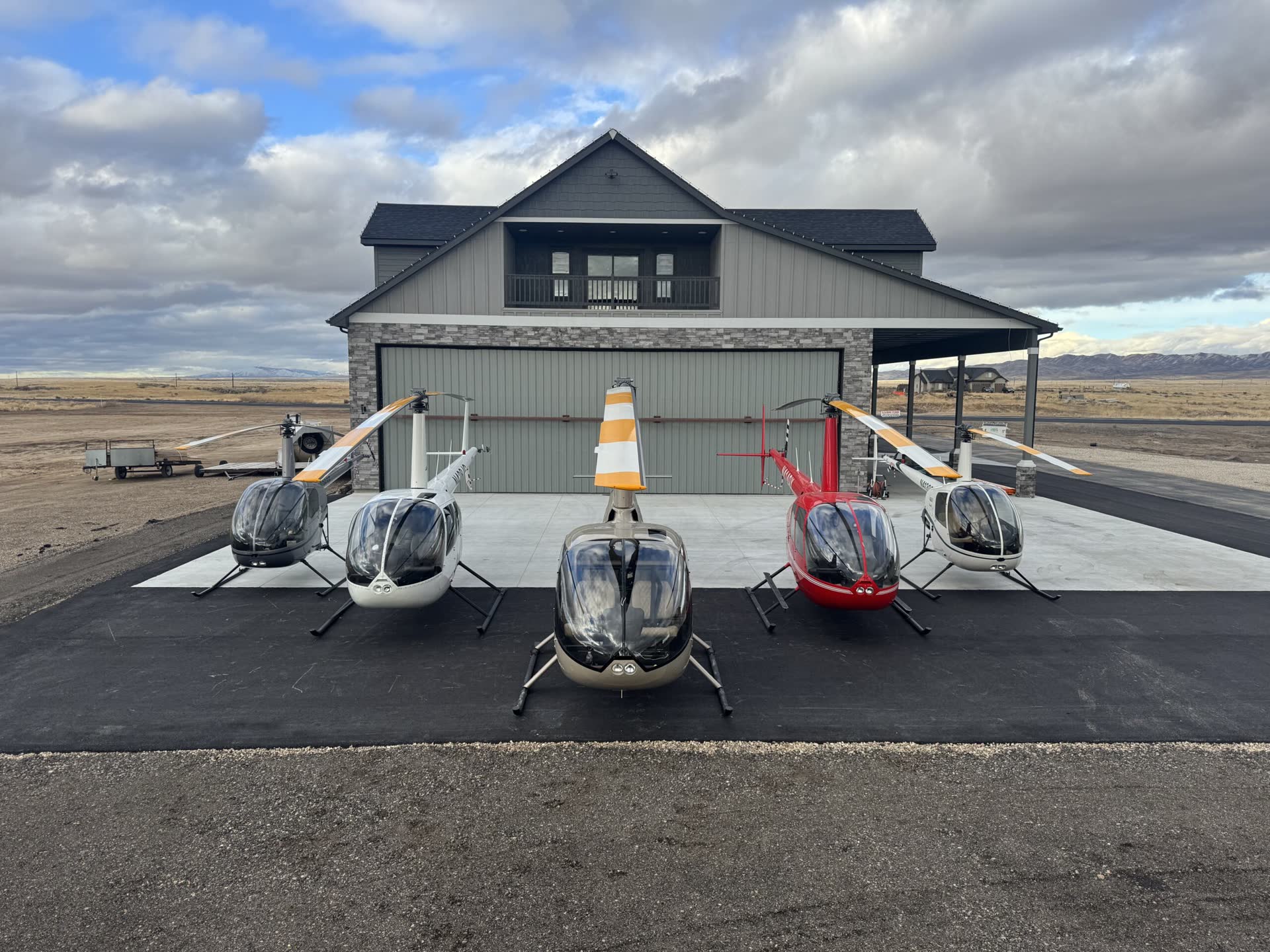 Alpine Aviation campus buildings with helicopters parked outside