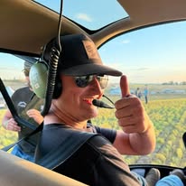 Student at the controls giving a thumbs up