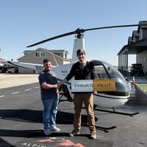 Student and instructor holding a Private Pilot sign